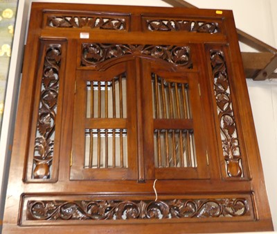 Lot 1097 - A reproduction carved mahogany garden mirror,...