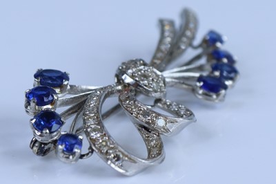 Lot 2652 - A white metal sapphire and diamond bow brooch...