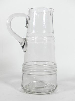 Lot 33 - A hand blown glass jug, of tapered and banded...