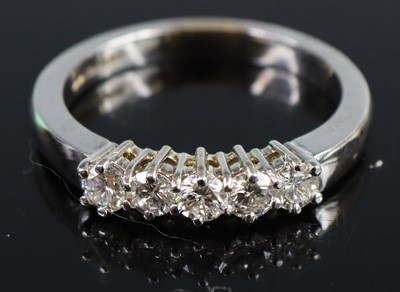 Lot 2674 - An 18ct gold diamond half eternity ring...