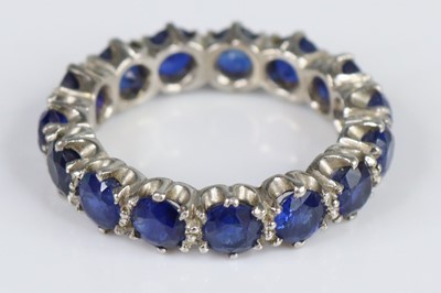 Lot 2663 - A white metal sapphire eternity ring featuring...