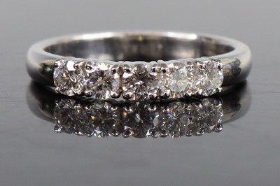 Lot 2667 - A white metal diamond half eternity ring...