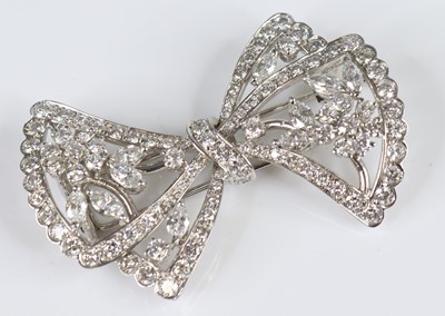 Lot A white metal diamond bow brooch, featuring 10...