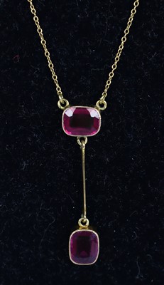 Lot 375 - A yellow metal pendant with 2 oblong red paste...