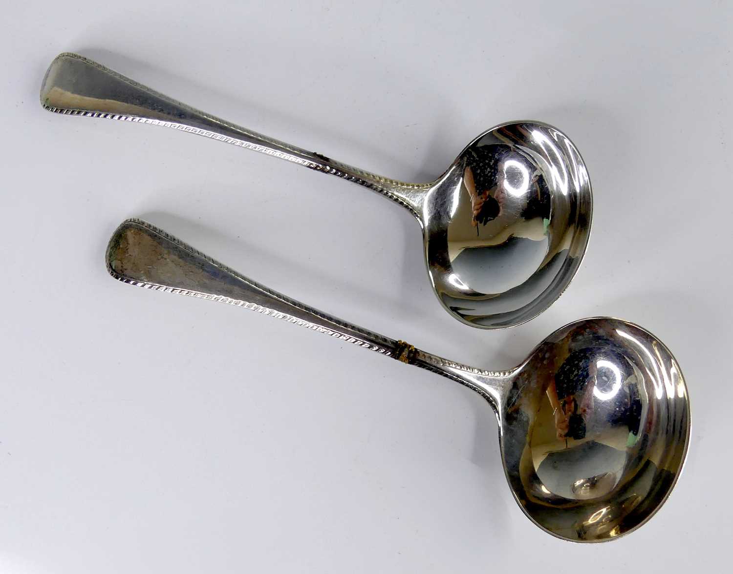 Lot 2103 - A pair of George III silver sauce ladles, in...