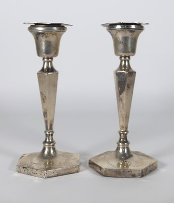 Lot 172 - A pair of George V silver table candlesticks,...
