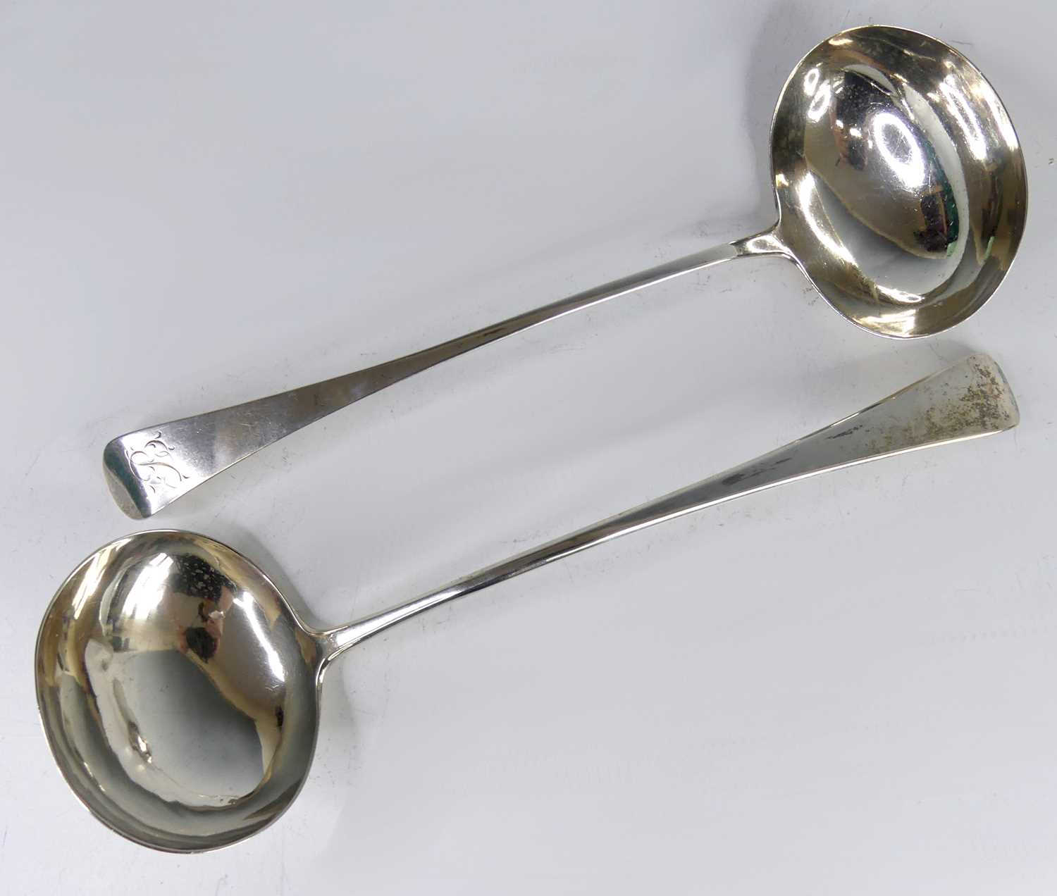 Lot 2106 - Two George III silver soup ladles, in the old...