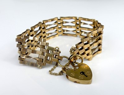 Lot 2520 - A 9ct gold gatelink bracelet with heart shaped...