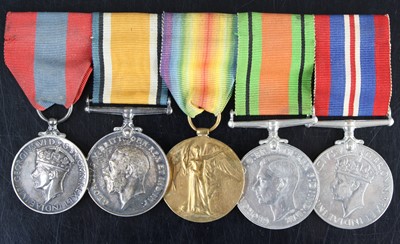 Lot 674 - A group of five medals to include George VI...