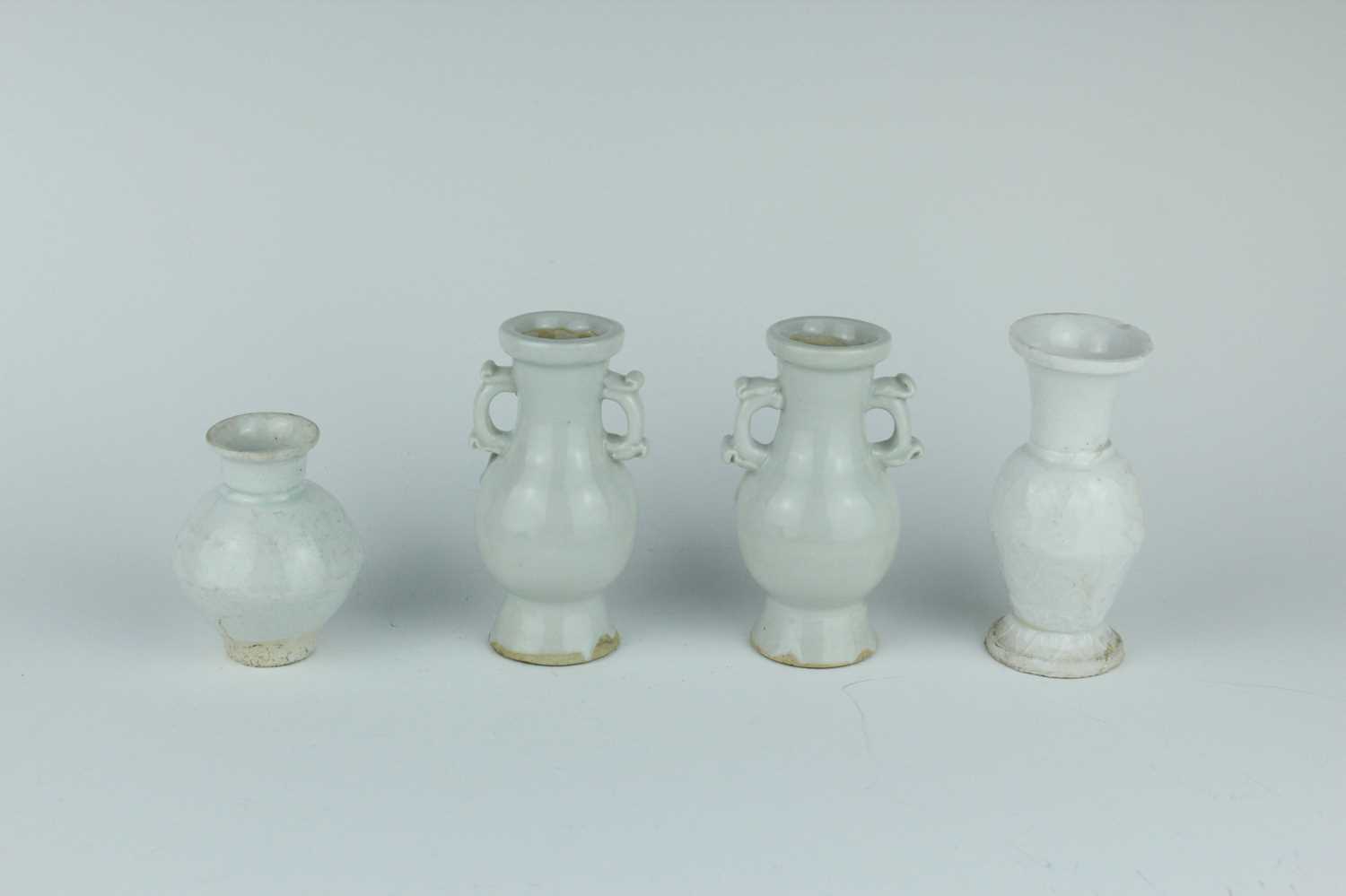 Lot 112 - A group of four small Chinese white and pale...