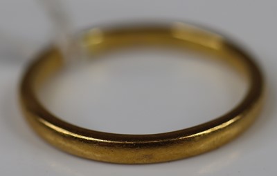 Lot 322 - A 22ct gold court shaped wedding band, size R,...