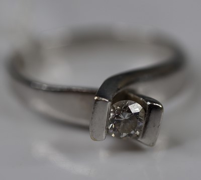 Lot 324 - A modern white metal diamond solitaire ring,...