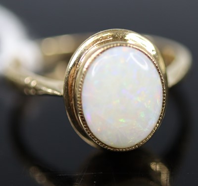 Lot 328 - A 9ct gold opal set dress ring, the bezel set...
