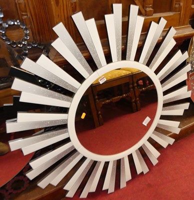 Lot 1129 - A contemporary starburst circular wall mirror,...