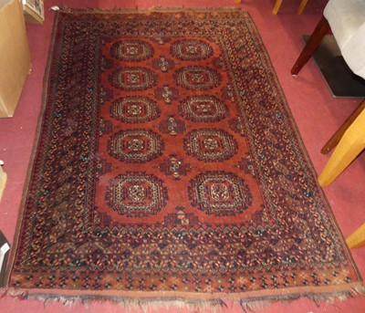 Lot 1180 - A Persian woollen red ground Bokhara rug,...