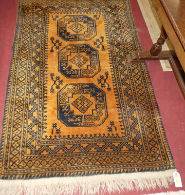 Lot 1184 - A Persian woollen rust ground Bokhara rug,...