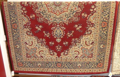 Lot 1192 - A Persian style red ground machine woven...