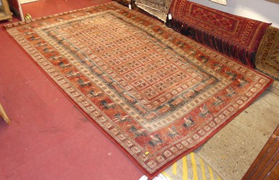 Lot 1196 - A Persian style red ground machine woven rug