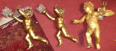 Lot 1211 - A pair of carved and gilt decorated cherub...