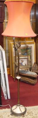 Lot 1219 - A brass and onyx standard lamp in the French...