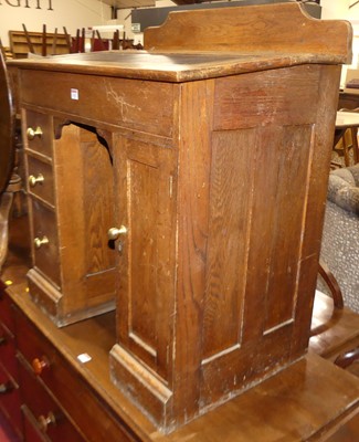 Lot 1262 - An early 20th century oak ledgeback slopefront...