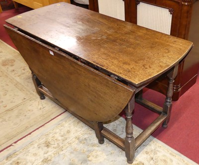 Lot 1265 - An 18th century provincial joined oak gateleg...