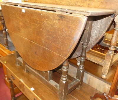 Lot 1276 - An antique joined oak gateleg dining table,...