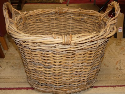 Lot 1300 - A wicker twin handled log basket, w.58cm;...