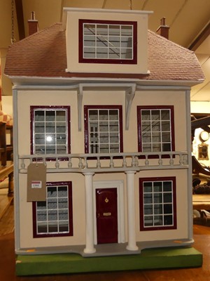 Lot 1304 - A three-storey dolls house, h.87cm, w.64cm