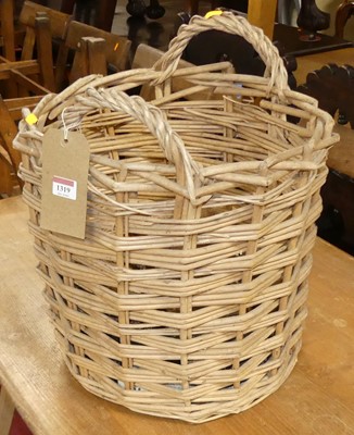 Lot 1319 - A wicker circular twin handled log basket, dia....
