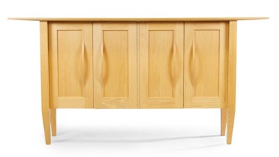 Lot 1332 - A contemporary blond oak four door sideboard,...