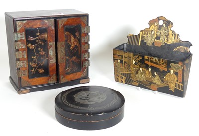 Lot 516 - A Japanese black lacquered table cabinet, the...