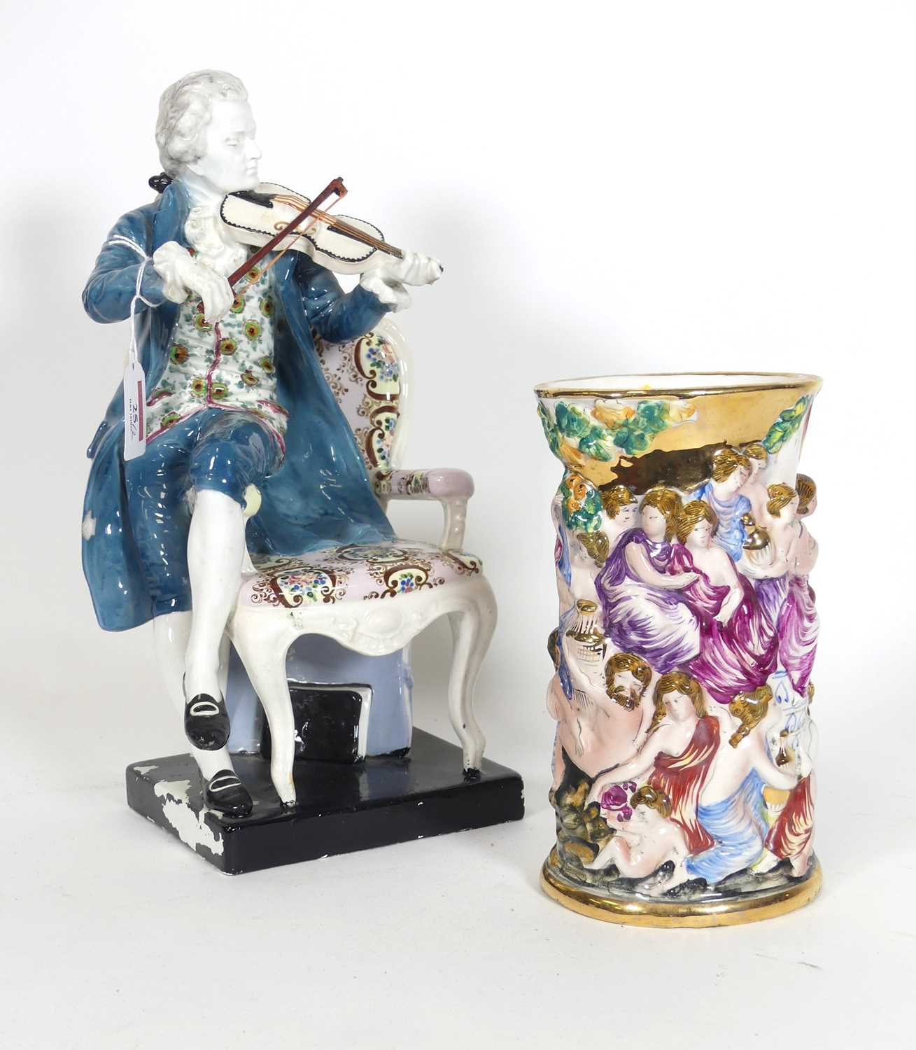 Lot 25 - A pottery figure of a violinist, modelled...