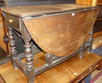 Lot 1386 - An antique joined oak gateleg dining table,...