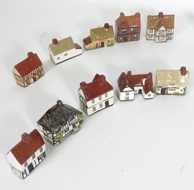 Lot 55 - A collection of Mudlen studio pottery cottages,...