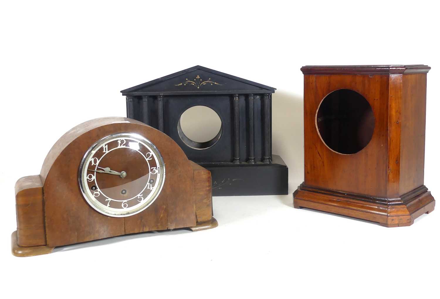 Lot 79 - A 1930s walnut cased mantel clock, the applied...