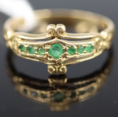 Lot 354 - A 9ct gold emerald set half-hoop ring, sponsor...