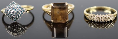 Lot 365 - A modern 9ct gold smoky topaz set dress ring,...