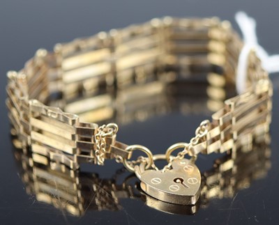 Lot 368 - A 9ct gold gatelink bracelet with heart shaped...