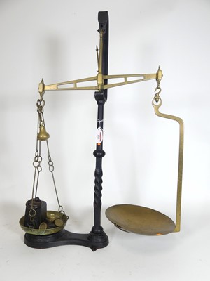 Lot 123 - A pair of brass balance scales, on cast iron...