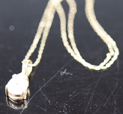 Lot 391 - A 9ct gold cz set pear shaped pendant, on...