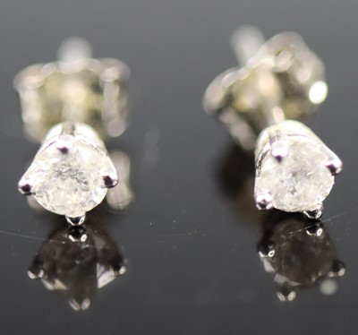 Lot 401 - A pair of 9ct white gold diamond ear studs,...