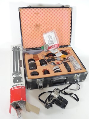 Lot 545 - A Nikon FM10 camera, with various associated...