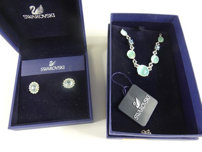 Lot 424 - A pair of boxed Swarovski Crystal ear studs;...