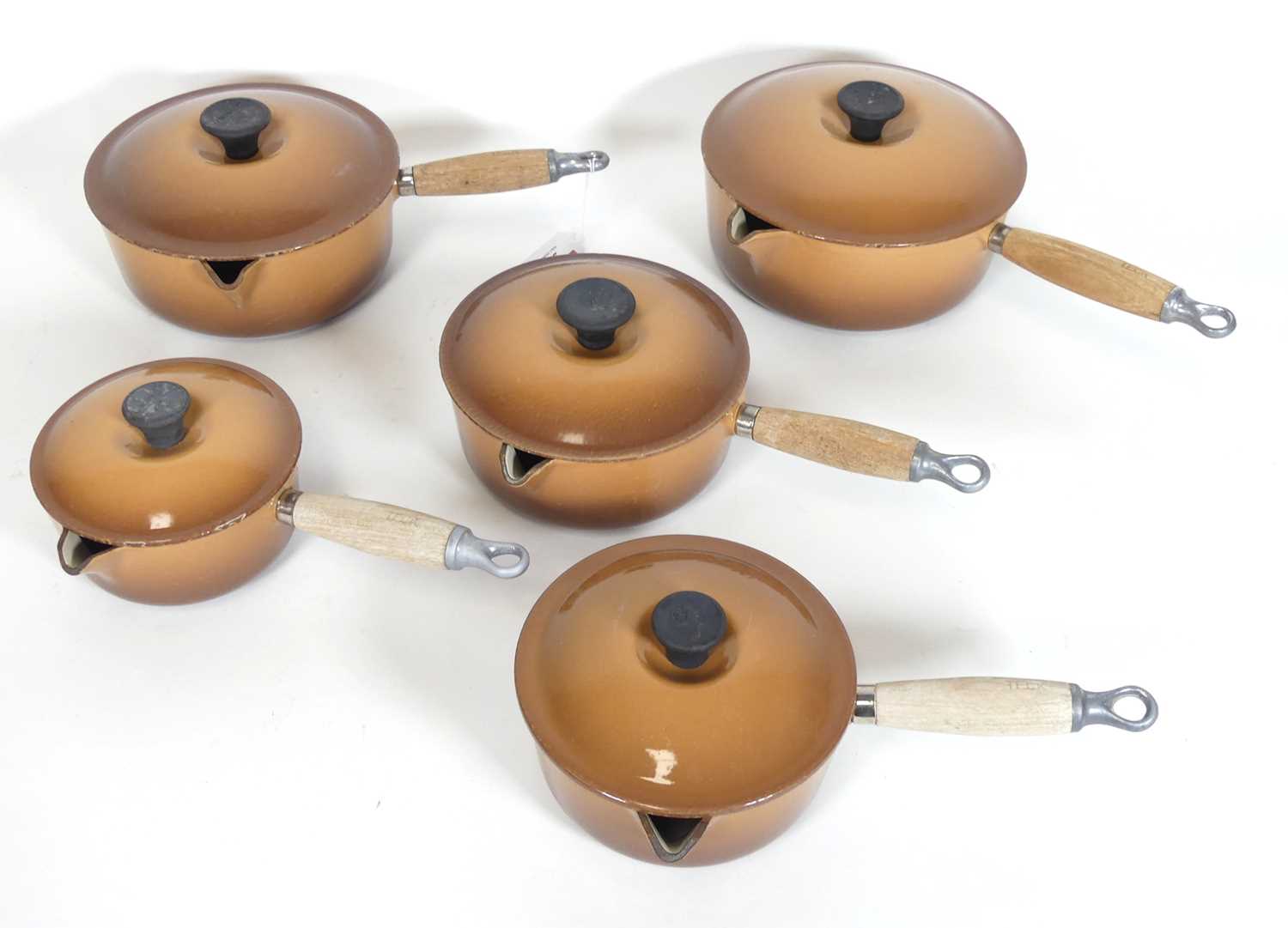 Lot 23 - A set of five Le Creuset brown enamelled cast...