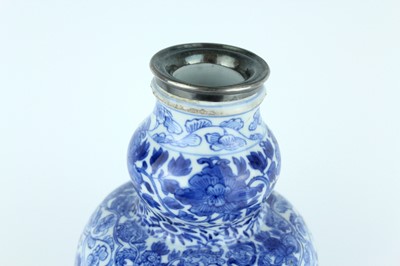 Lot 19 - A Chinese blue and white gourd vase, Qing...