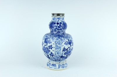 Lot 19 - A Chinese blue and white gourd vase, Qing...