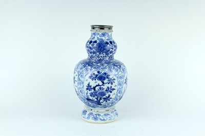 Lot 19 - A Chinese blue and white gourd vase, Qing...