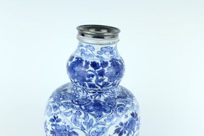 Lot 19 - A Chinese blue and white gourd vase, Qing...