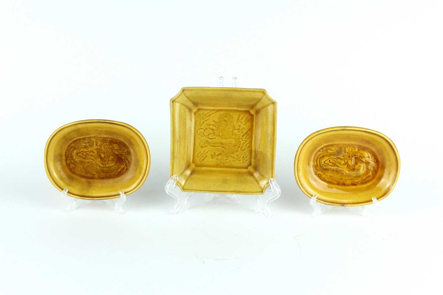 Lot 93 - Three Chinese yellow-glazed ‘dragon’ dishes,...